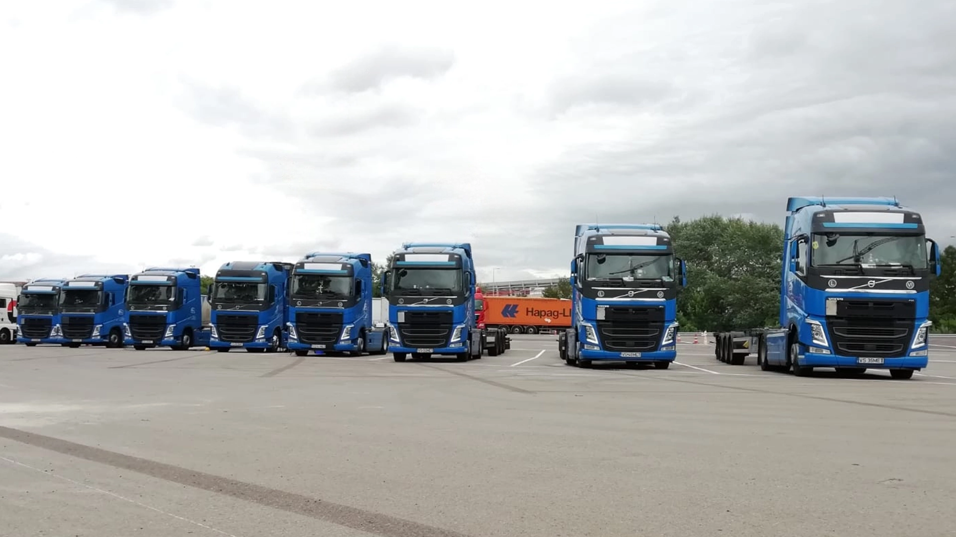 Camioanele din flota Realmet Logistic fotografiate in parcarea unui port european